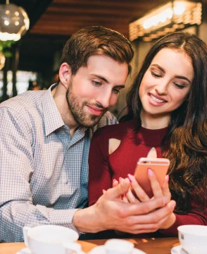 young-people-are-sitting-together-cafe-looking-phone-they-look-happy-calm-1